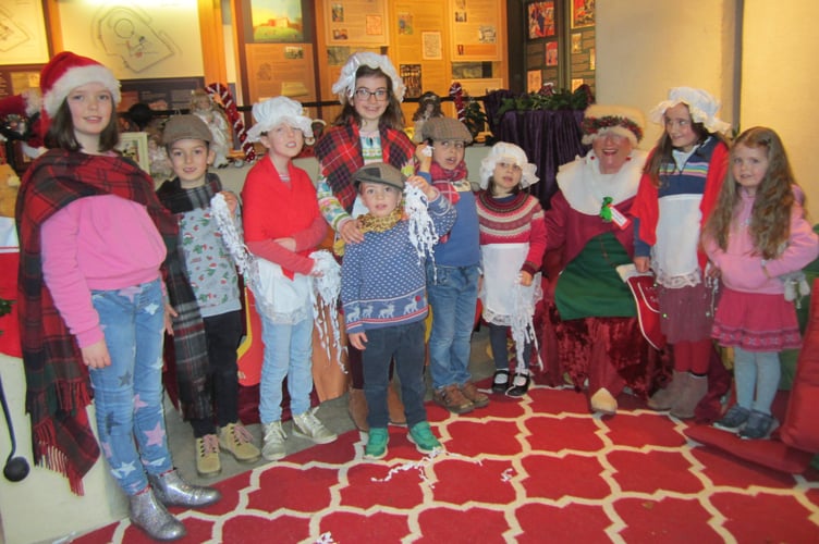 Farnham storyteller Gilly Stewart with her merry band of Victorian children at Farnham Castle
