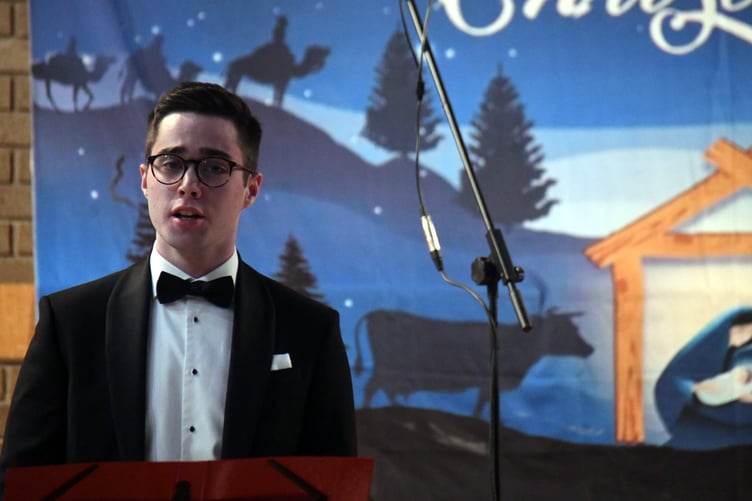 *** Local Caption *** Sam Britner performing Silent Night.