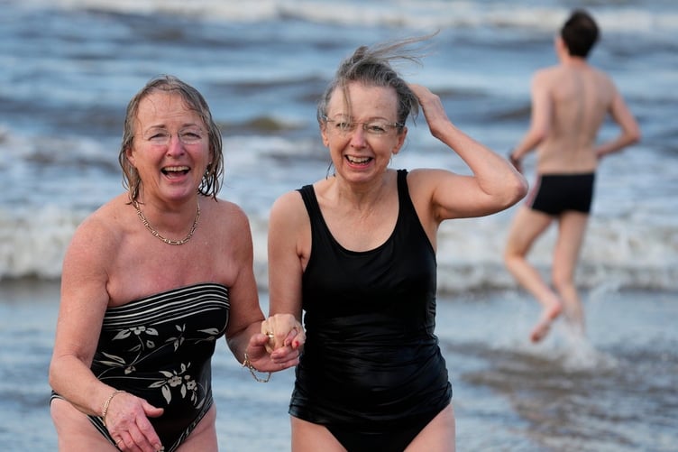 Two sisters from New York brush off the chill during New Years Day dip Barmouth.