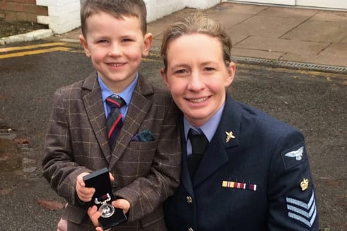 WO Fiona Phillips and her son Henry with her MBE.