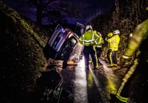 Fire crews help man escape as car ends up on its side