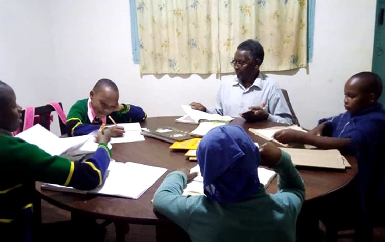 Teacher giving extra lessons at the Coral Home