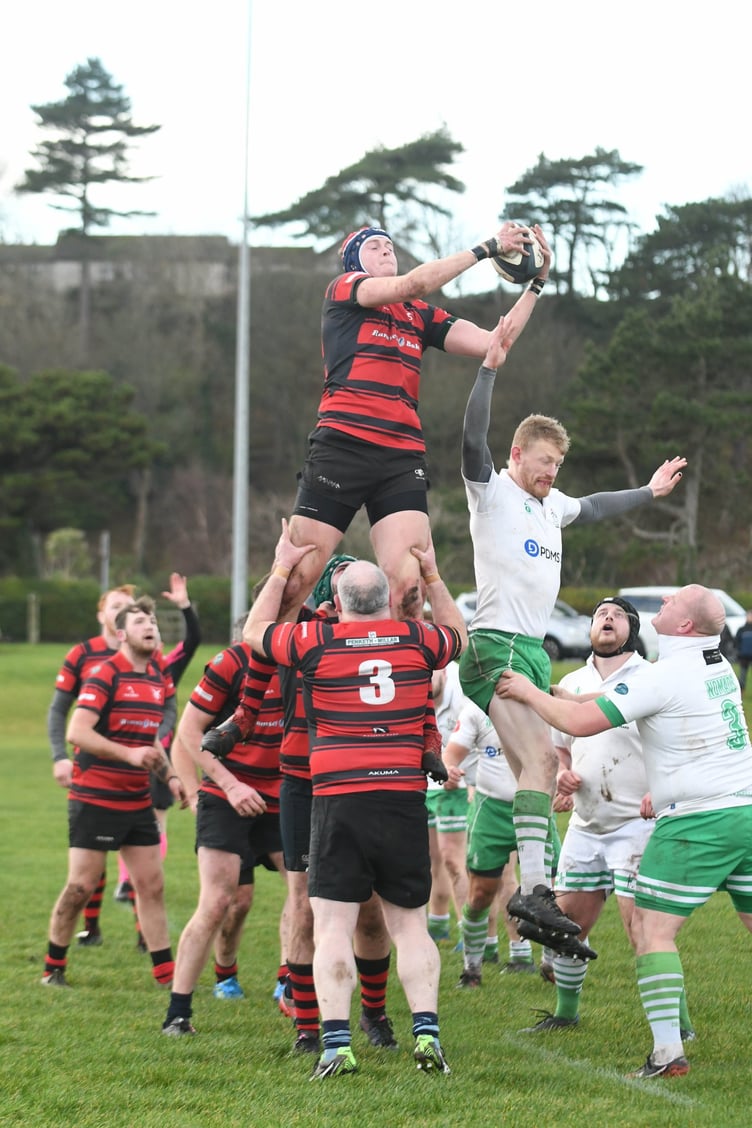 Nomads Whites pace men Tom Collister (with ball) and Tony Quinn isolate Ramsey wing Simon Corlett (red and black No.11) during Saturday’s Manx Shield encounter at Mooragh Park (Dave Kneale DK230107(14))
