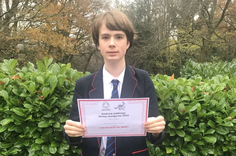 Royal School pupil Rufus Sharp with his merit certificate