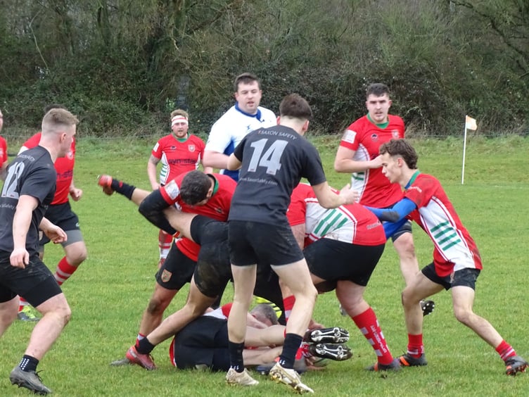 Lee Jones (on the ground) secures possession for Petersfield