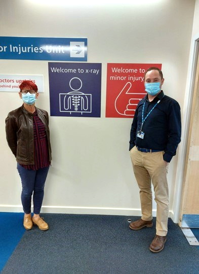 Cilla Long, patient experience officer and David Wilson, area director for North and East Cornwall proudly displaying some of the new signs at Bodmin hospital