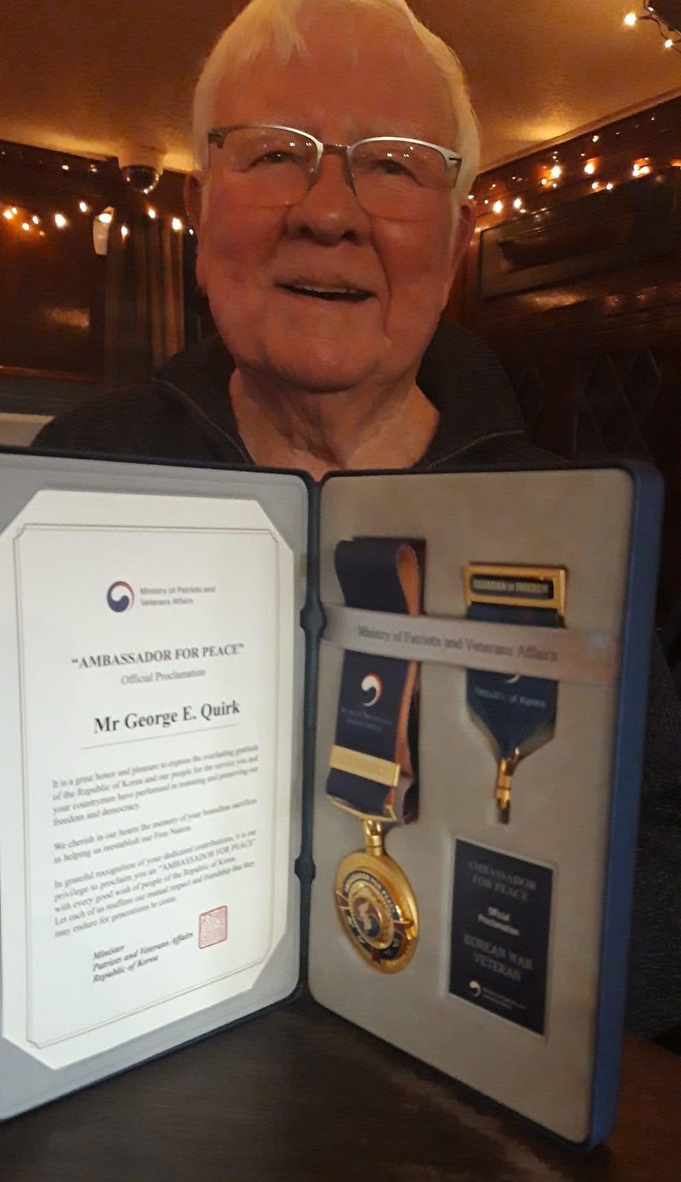 Eric Quirk with his Ambassador for Peace medal from the Korean Embassy