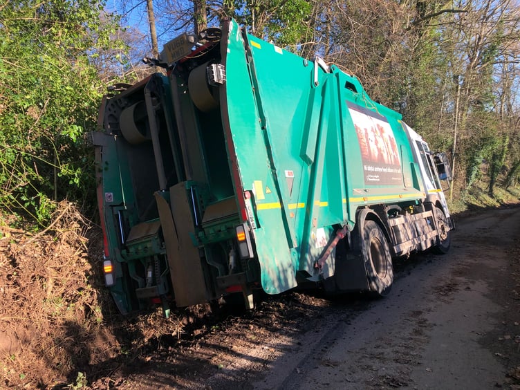 The bin lorry blocked the road after getting trapped in the ditch