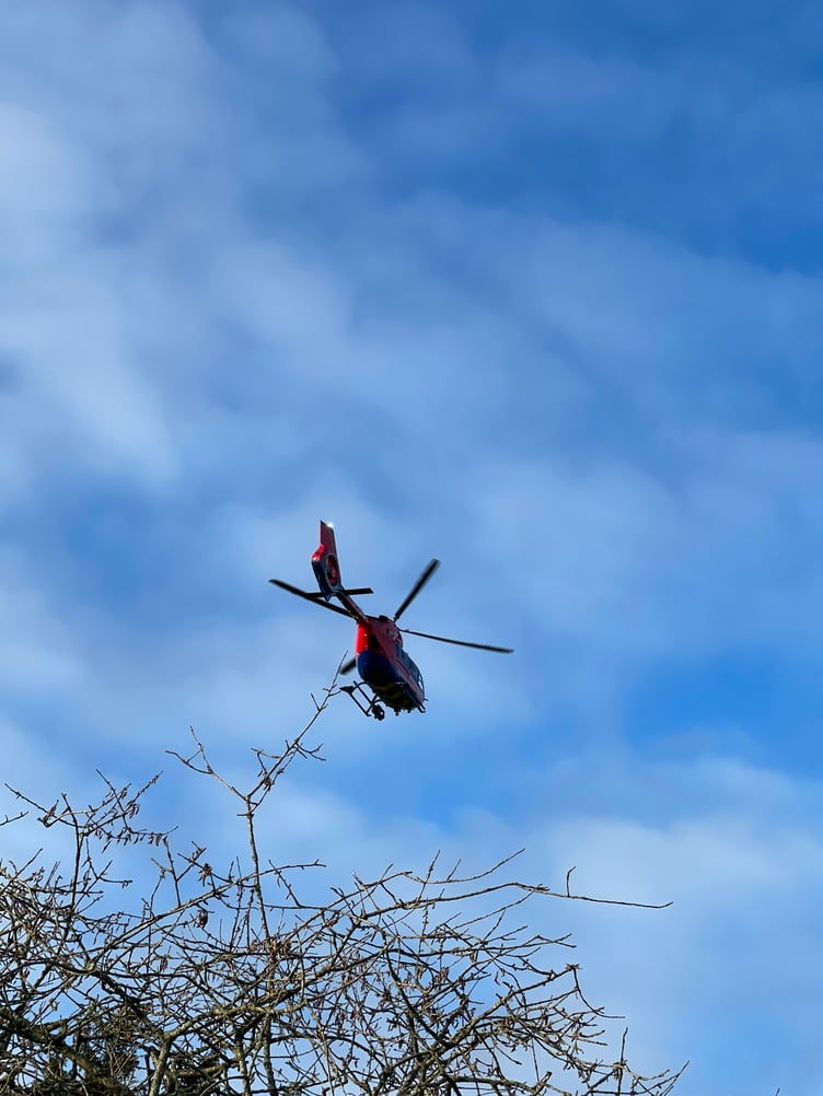 The Air Ambulance about to land in Newcombes Meadow. AQ 2302