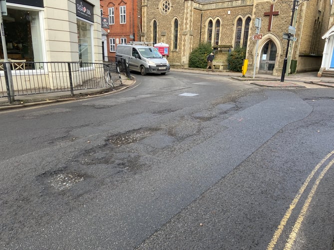 The road surface at the junction of South Street and Union Road is breaking up after the recent cold snap. This photo was taken on Tuesday (January 31) afternoon, when the sub-layer of the road was clearly visible and gravel was strewn across the highway. The Herald has shared these images with Surrey County Council.