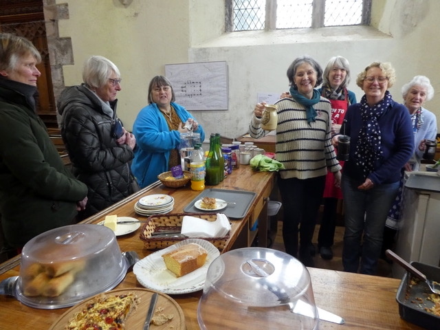 Ladies serving coffee and cake.