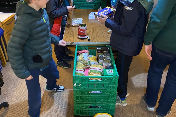 A group from 8th Farnham Scouts helped out at Farnham Food Bank last week