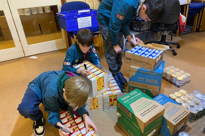 8th Farnham Scouts spent an hour weighing, dating and sorting food donations for distribution to those in need