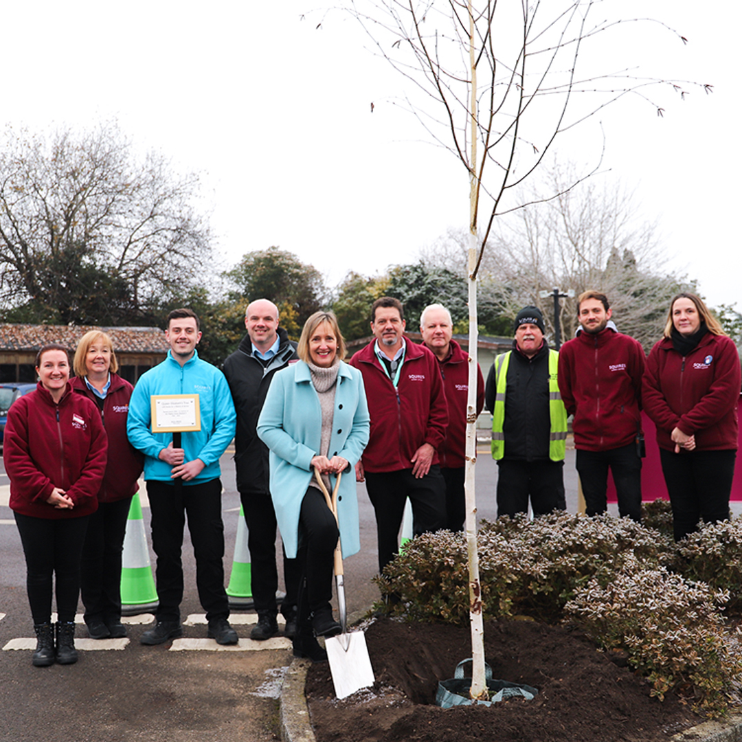 Sarah Squire (centre) joins staff at Squire’s in Badshot Lea to plant the new tree