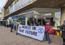 Extinction Rebellion ‘suffragettes’ chain themselves in Guildford bank