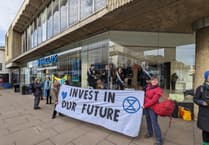 Extinction Rebellion ‘suffragettes’ chain themselves in Barclays’ Guildford branch