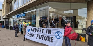 Extinction Rebellion ‘suffragettes’ chain themselves in Guildford bank