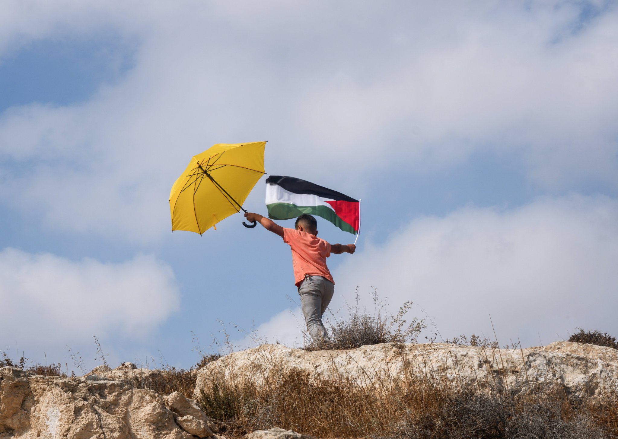 A child waves a flag in the South Hebron Hills, where Debby is mostly based