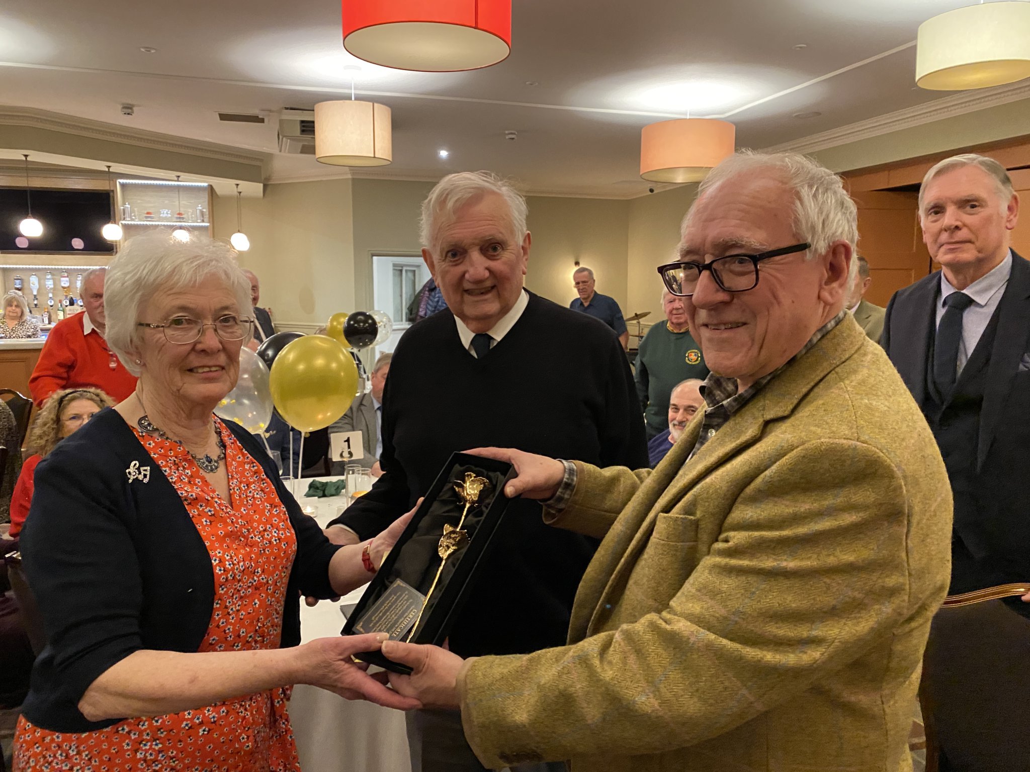 Rosemarie Lewis is presented with a golden rose by choir chairman David Benson with her husband Clive (centre) looking on.
Below Rosemarie at the piano at Rockfield Studios used by Freddie Mercury and Queen to record Bohemian Rhapsody. Picture courtesy of Naylor Firth.