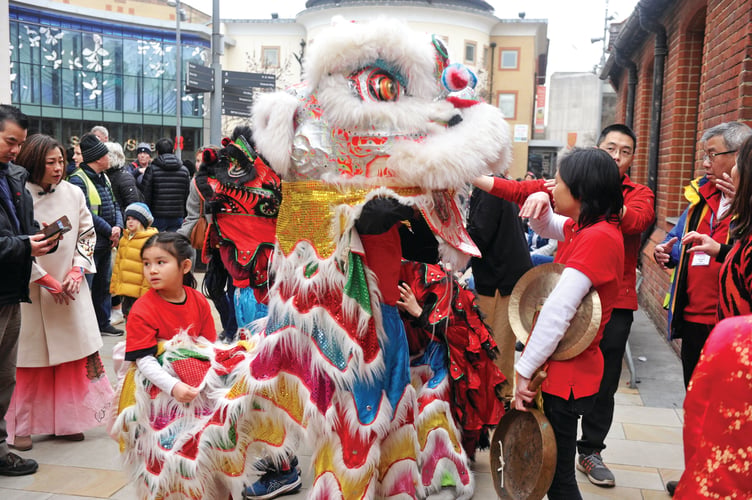 Lion dancers ready for their parade through Jubilee Square.