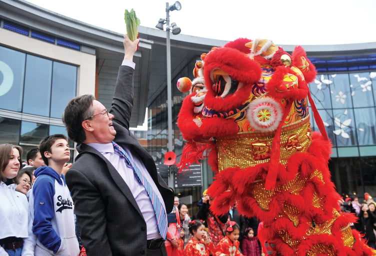Woking MP Jonathan Lord gives a lettuce to a lion.