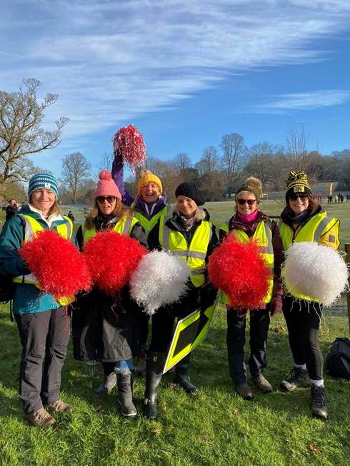 Marshals prepare to cheer on the runners with bright bobble hats and pom-poms