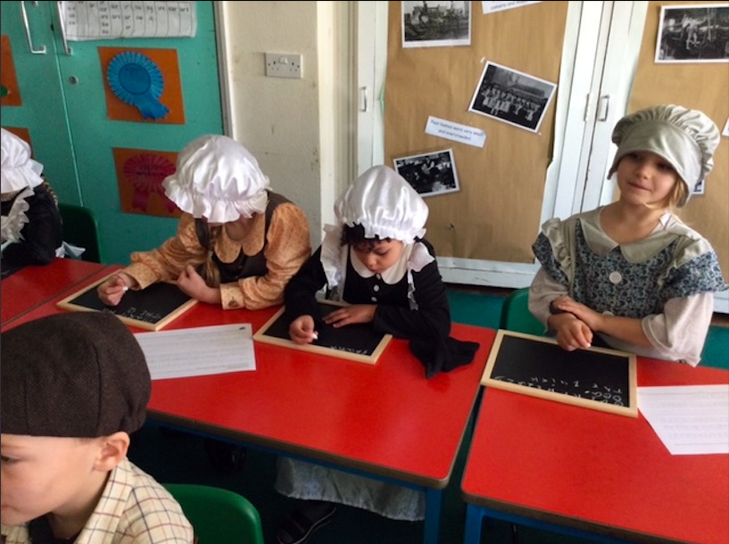 Children tried their hand at writing on chalkboards as part of the time travelling experience