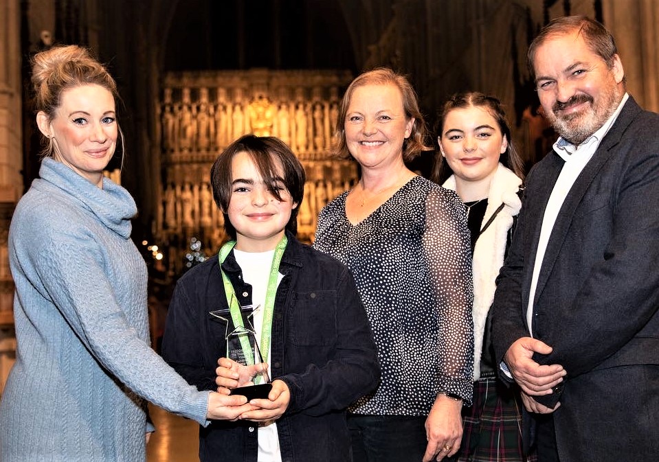 Freddie is presented with his Young Fundraiser of the Year award by actress Kellie Shirley, who played Carly Wicks in EastEnders, with mum Nicola, sister Emily and dad James.