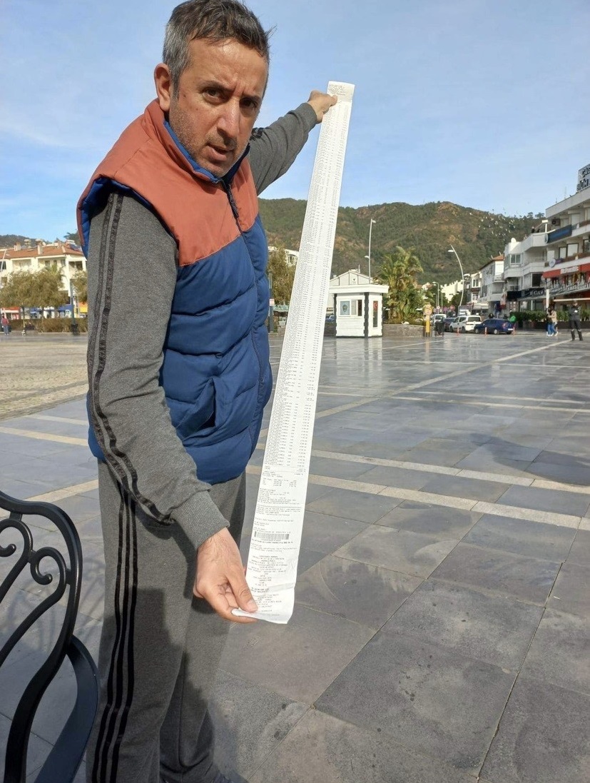 Hakan Kus, a volunteer helping those affected by the earthquake in Turkey, with a receipt for a shop for supplies