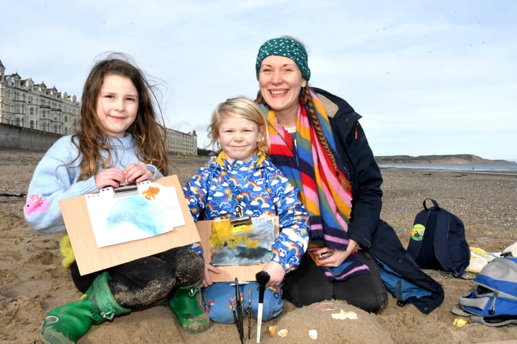 Painting on Ramsey beach with Manx Wildlife Trust artist in residence Clare Payne, as part of Love Your Beach Week - pictured is Boudica Haith (6) and Launcelot Haith (3) with mum Verity Charlesworth