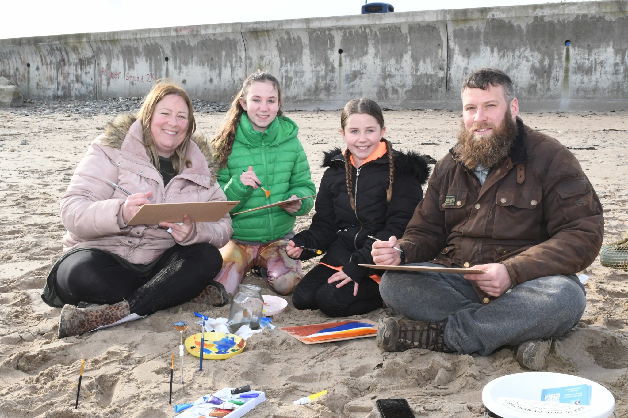 Painting on Ramsey beach with Manx Wildlife Trust artist in residence Clare Payne, as part of Love Your Beach Week - pictured are members of the Slater family