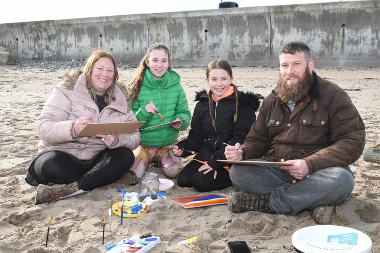 Painting on Ramsey beach with Manx Wildlife Trust artist in residence Clare Payne, as part of Love Your Beach Week - pictured are members of the Slater family