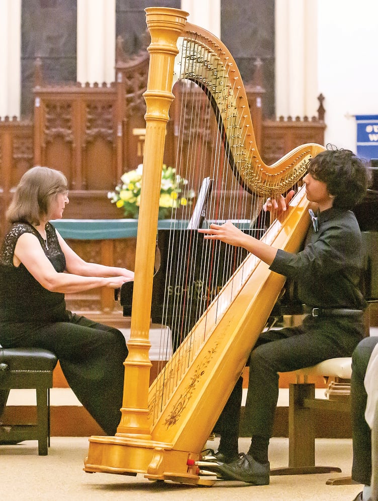 Jamaal Kashim playing the harp.