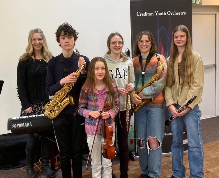 Young soloists from Crediton Youth Orchestra with director Alison Golby.