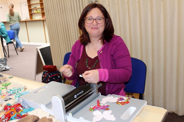 Catherine West, Director of Significant Seams, with some of the pieces from the die cut machine she is using for the Sustainable Crediton banner. SR 6986