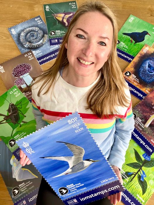 Clare Payne pictured with her stamp designs to celebrate the Manx Wildlife Trust's 50th anniversary