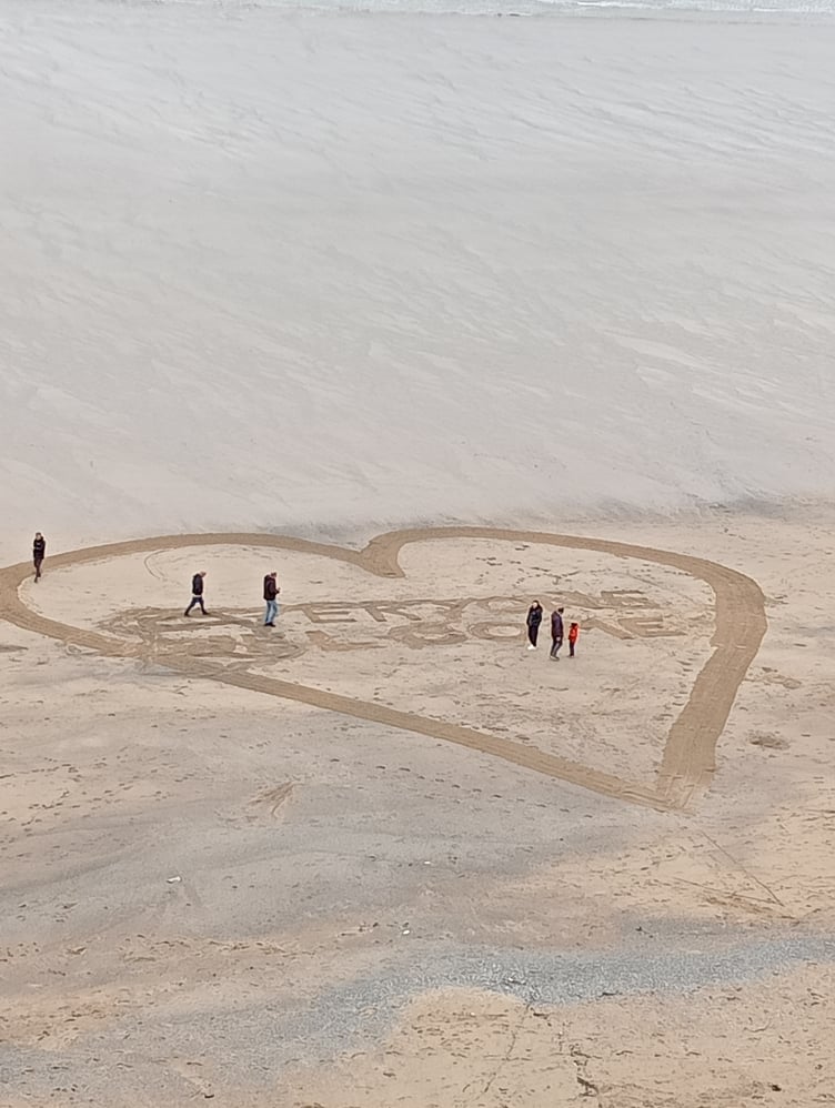 "Refugees welcome" sand art was created on Tolcarne Beach, below the scene of the protest