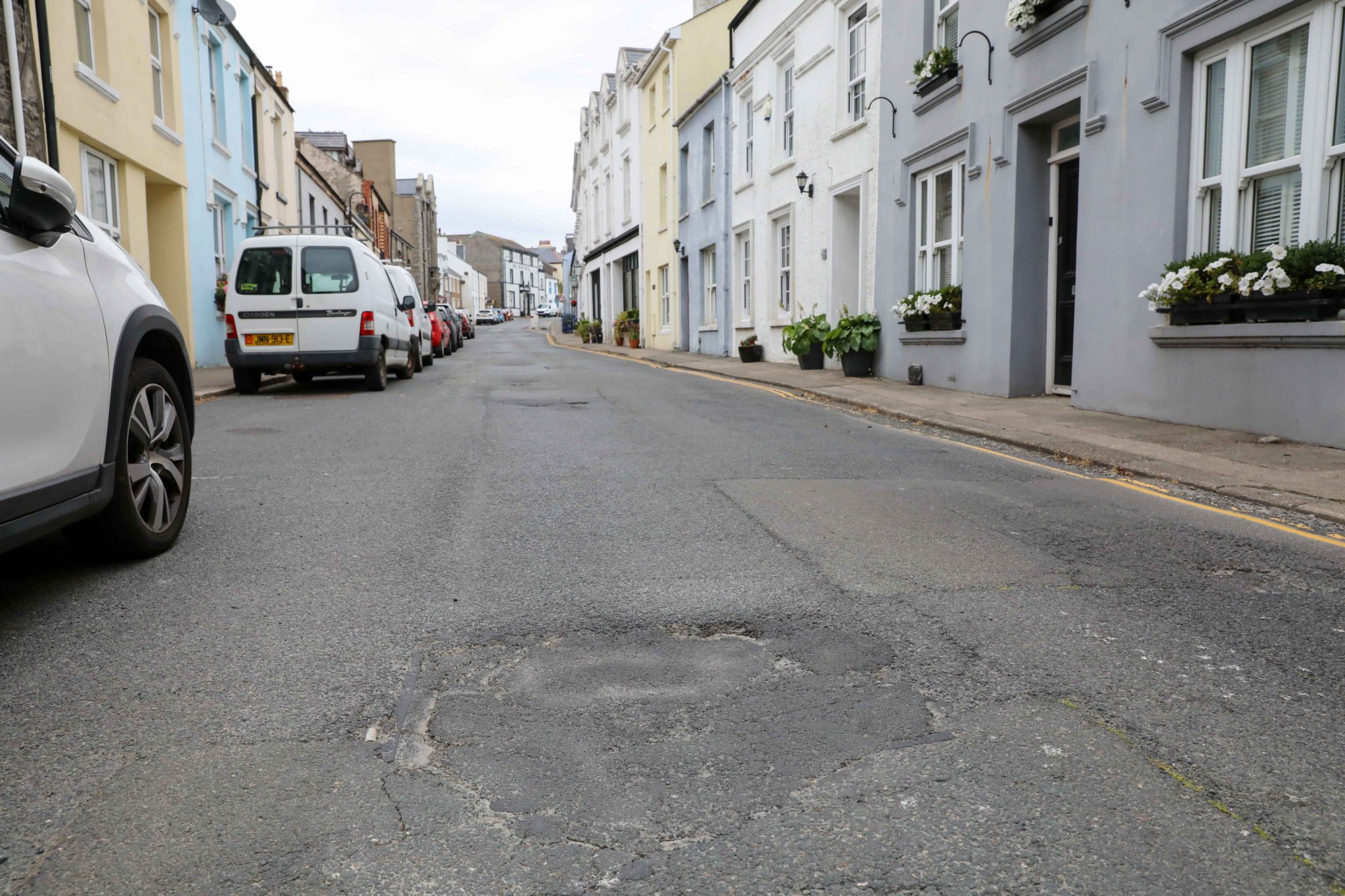 The village high street is badly potholed