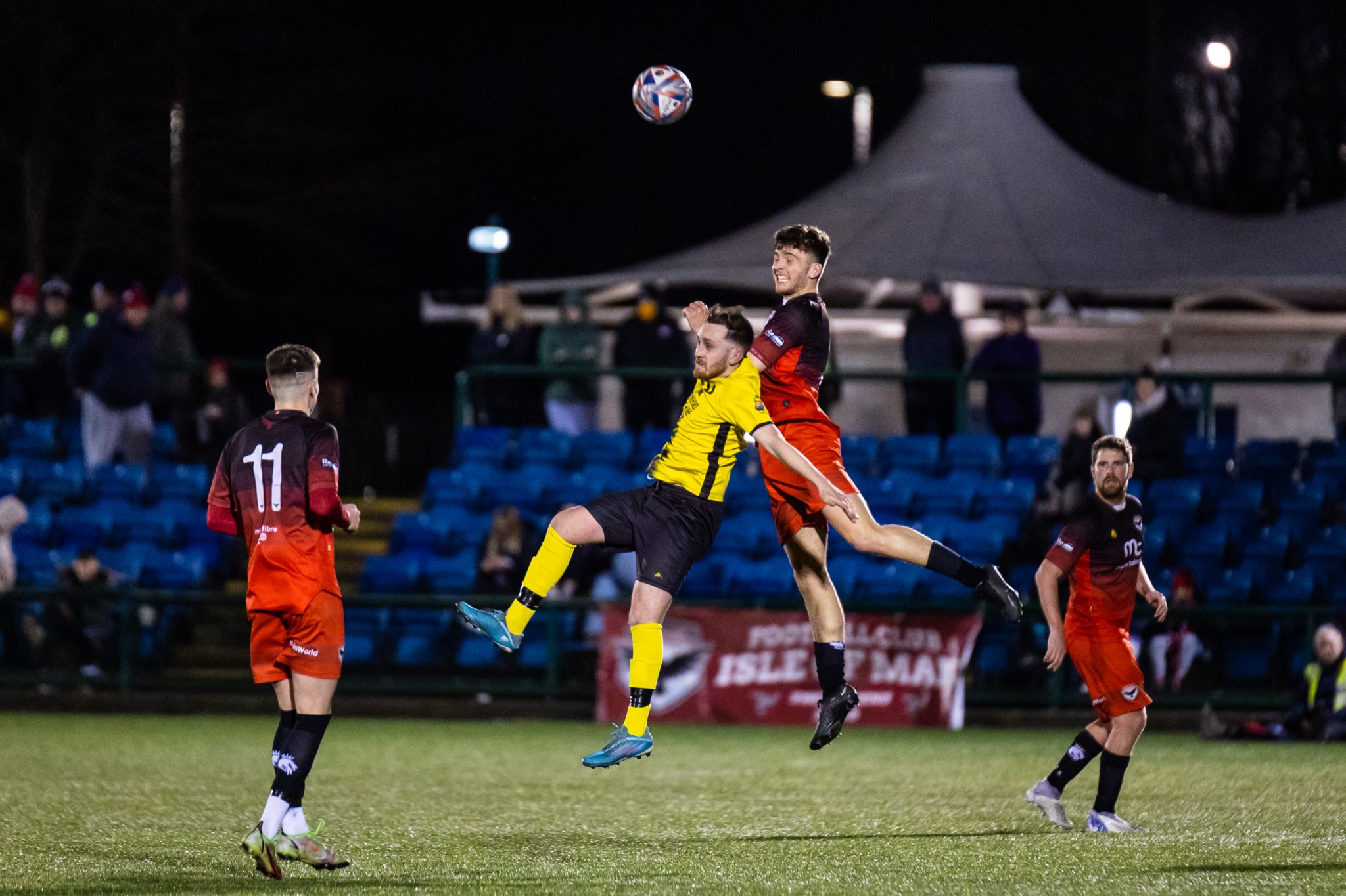 FC Isle of Man’s Jacob Crook rises above a Winsford United opponent to win a header during Saturday’s North West Counties Football League clash at the Bowl. Crook helped the Ravens triumph 1-0 (Photo: Gary Weightman)