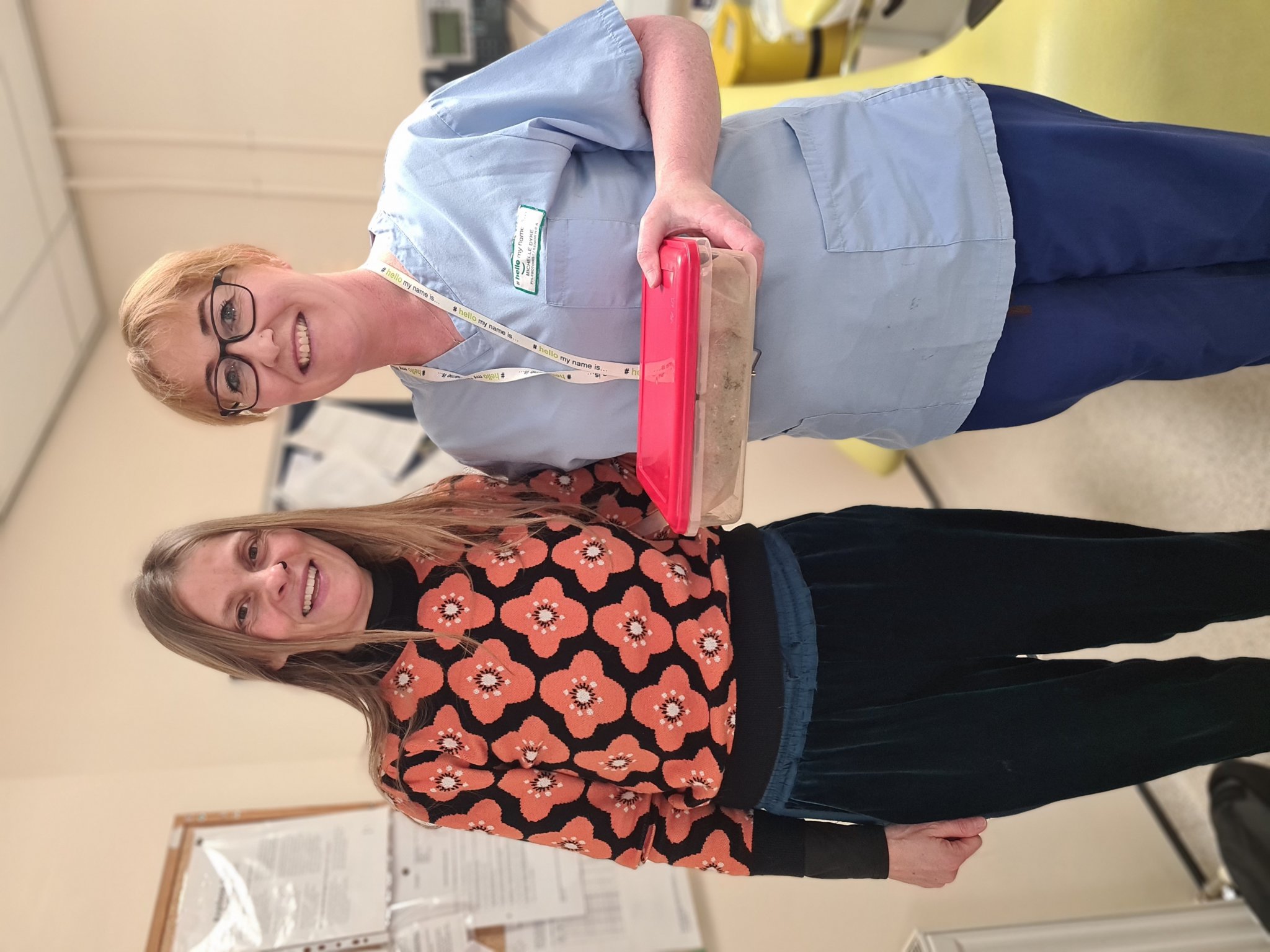 Jackie Morrey-Grace presents Michelle Dyke from Ramsey Cottage Hospital Blood Clinic with a cake for the #BeKind2023 Without Wings campaign