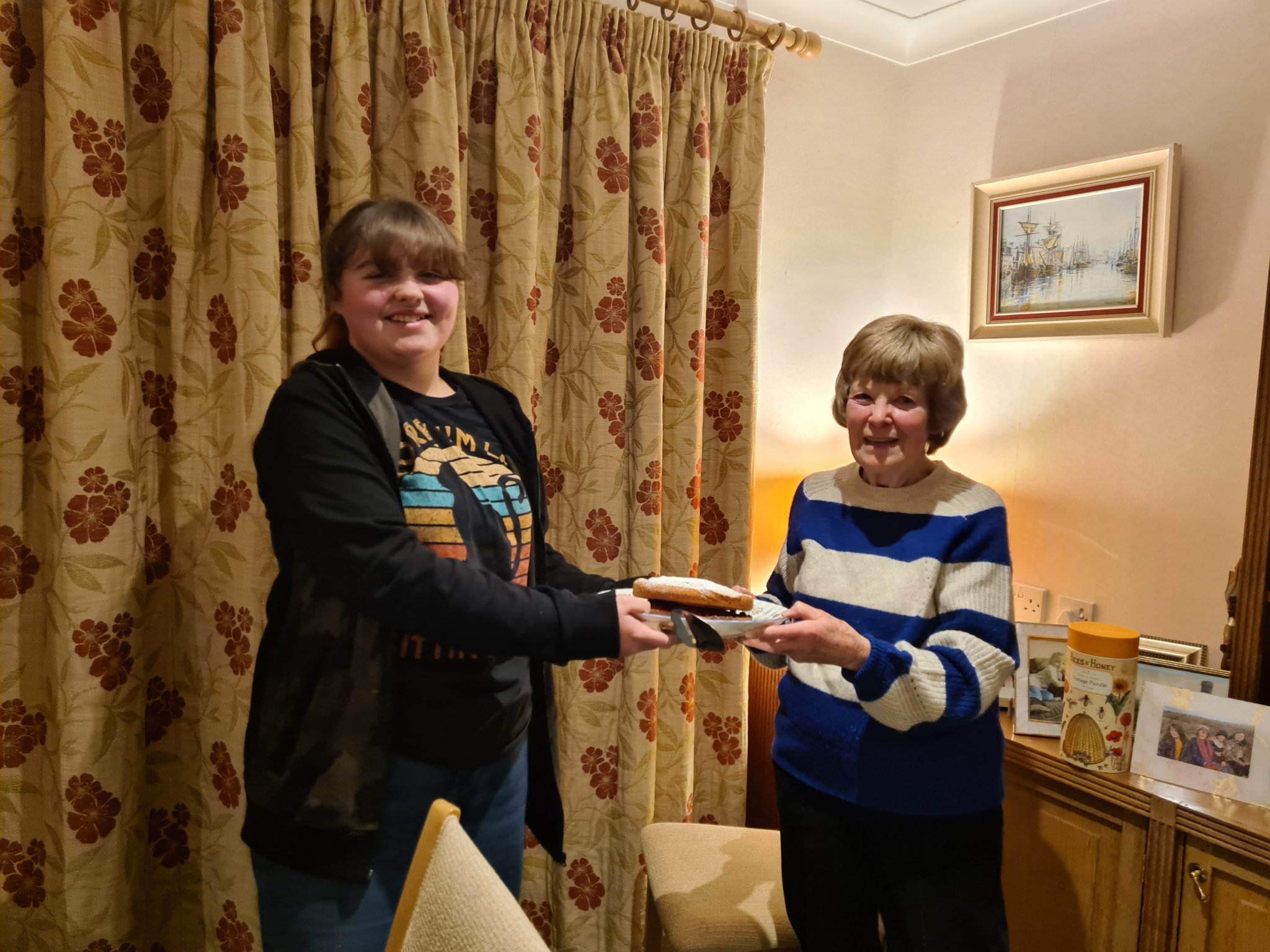 Maeve Morrey gives a cake to nana Sue Grace for the #BeKind2023 Without Wings campaign