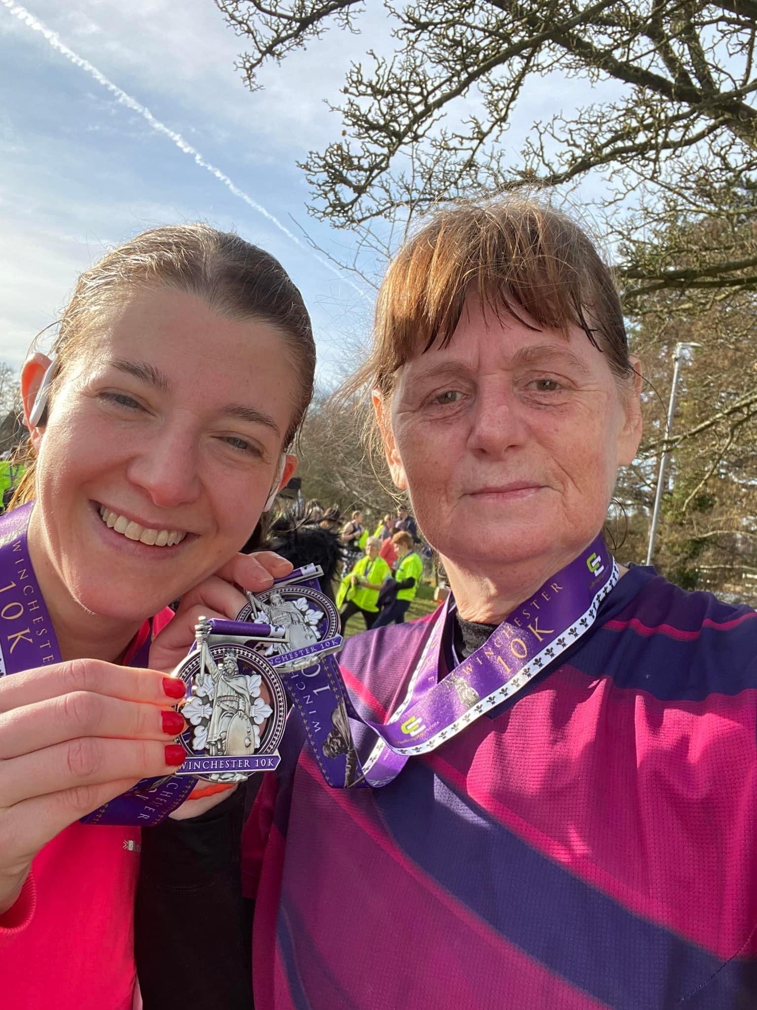 Gemma Reeder and Janet Govan proudly show off their Winchester 10k medals