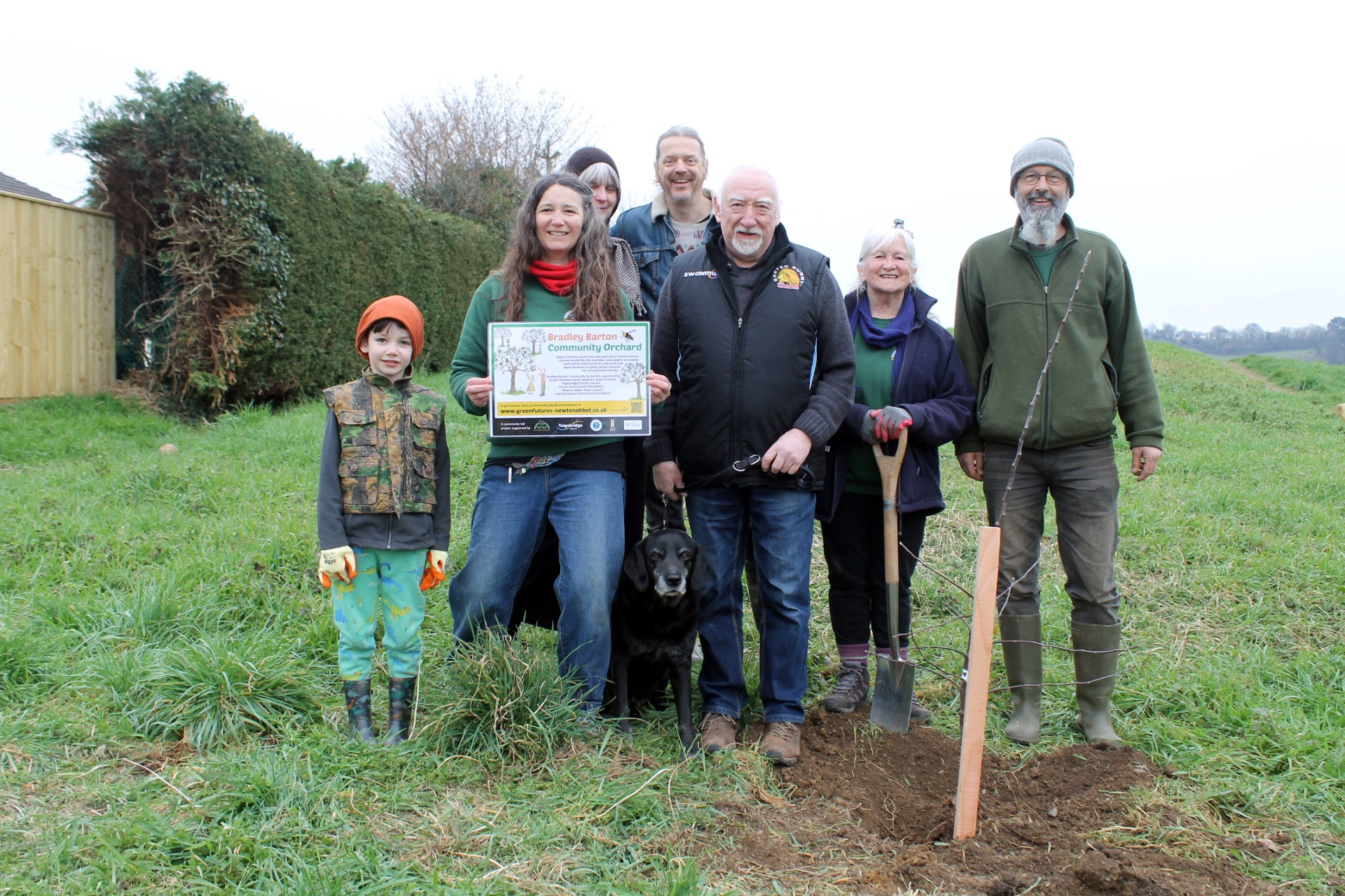 Green Futures chairperson Sam Hibbert, Clr Mike Hocking, centre, and Andrew Rothery, right, with Bradley Barton orchard volunteers.