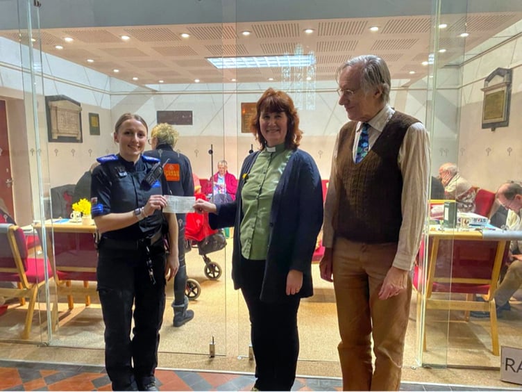 PCSO Sandie Williams presents cheques to representatives of Ffrij Tywyn Community Fridge (left) and St Cadfan’s Church (right)