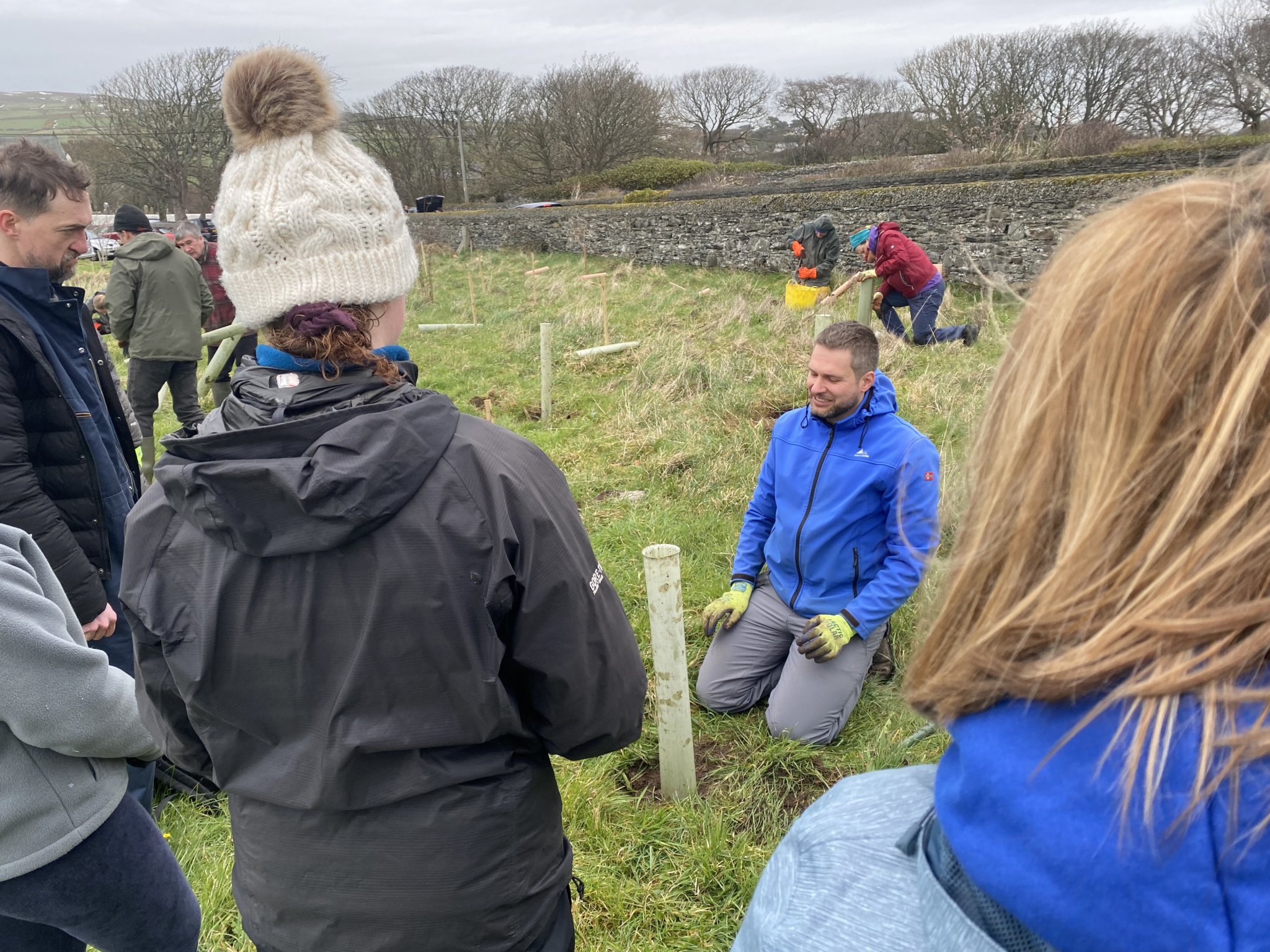 Falk Horning of the Isle of Man Woodland Trust demonstrates how to plant a sapling to volunteers on Sunday morning