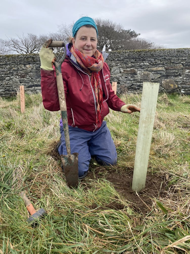 Catherine Cairns with her sapling she has planted