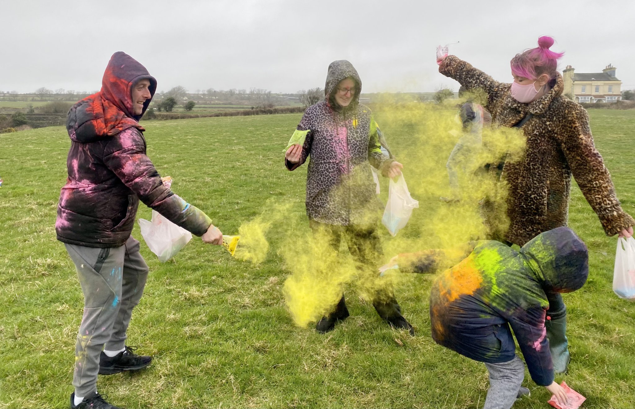 The Slade family throw coloured powder over each other