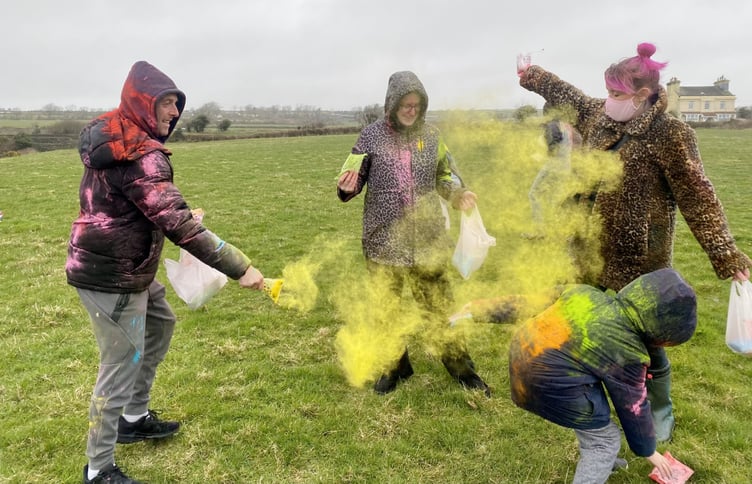 The Slade family throw coloured powder over each other