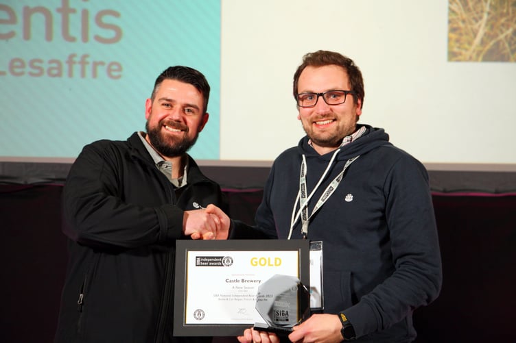 ABOVE: Simon, head brewer and owner at Castle Brewery, receiving the awards for their beer (left)