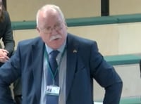 <p>Surrey County Councillor Trefor Hogg reading the imagined letter at a meeting of the council. Screengrab from meeting stream</p>